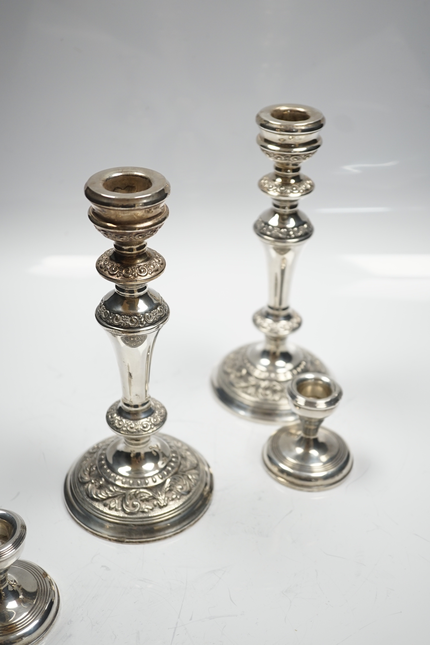 A modern pair of silver mounted candlesticks, Broadway & Co, Birmingham, 1991, 22.23cm and a pair of silver mounted dwarf candlesticks.